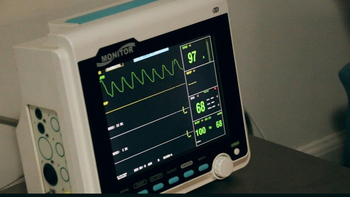 Bedside patient monitor displaying vital signs