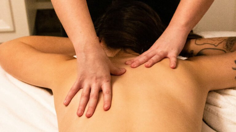 Massage therapist working on a client's upper back